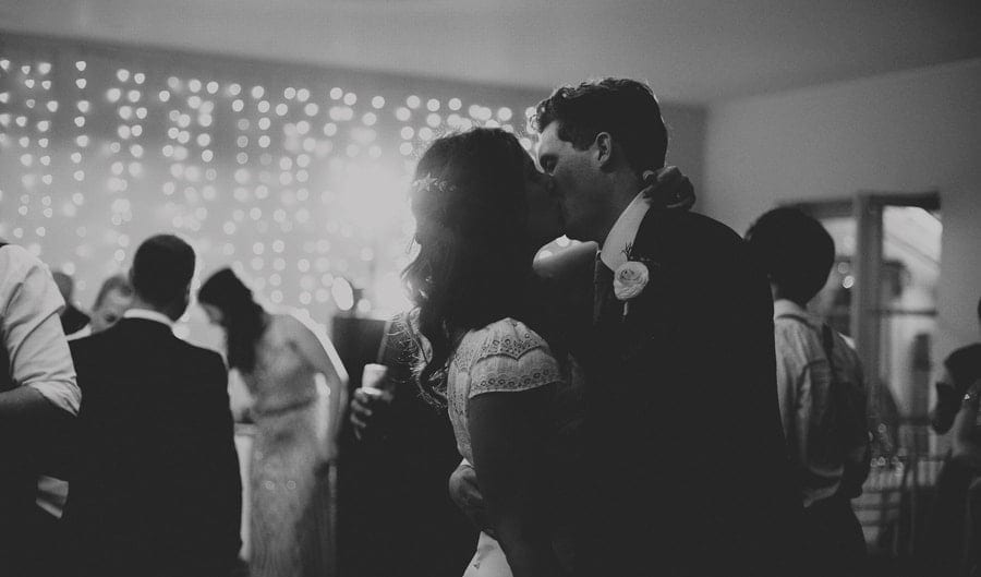 The bride and groom kiss on the dancefloor at the Matara Centre
