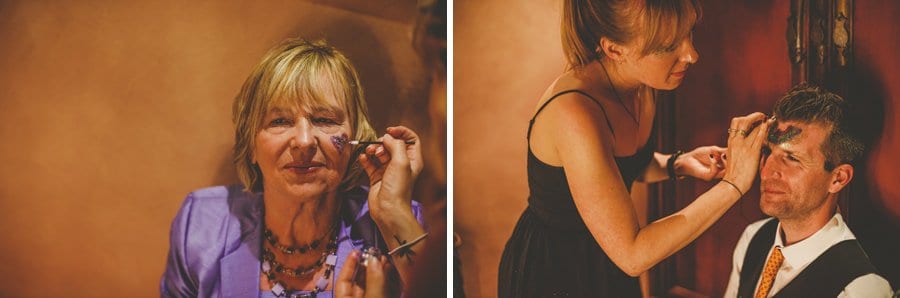 The make up artist paints glitter on the faces of the wedding guests
