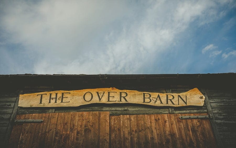 A wooden plaque that reads THE OVER BARN hangs above the barn doors