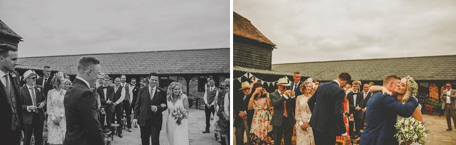 The bride and groom greet each other in the courtyard at Over Barn