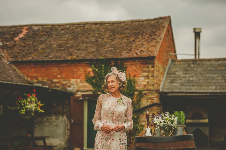 The grooms mother make a speech during the outdoor ceremony at Over Barn