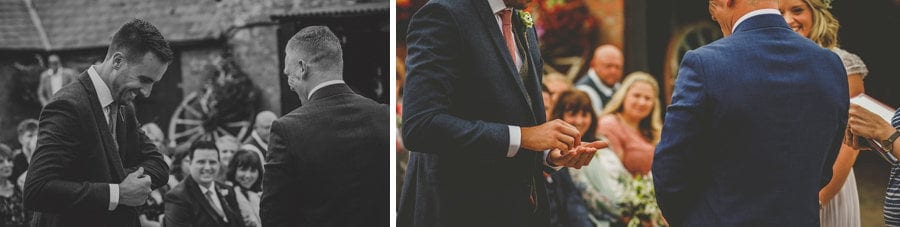 The best man gives the groom the wedding rings during the outdoor wedding ceremony