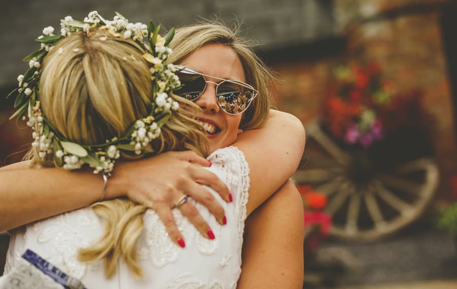 A wedding guest congratulates the bride in the courtyard