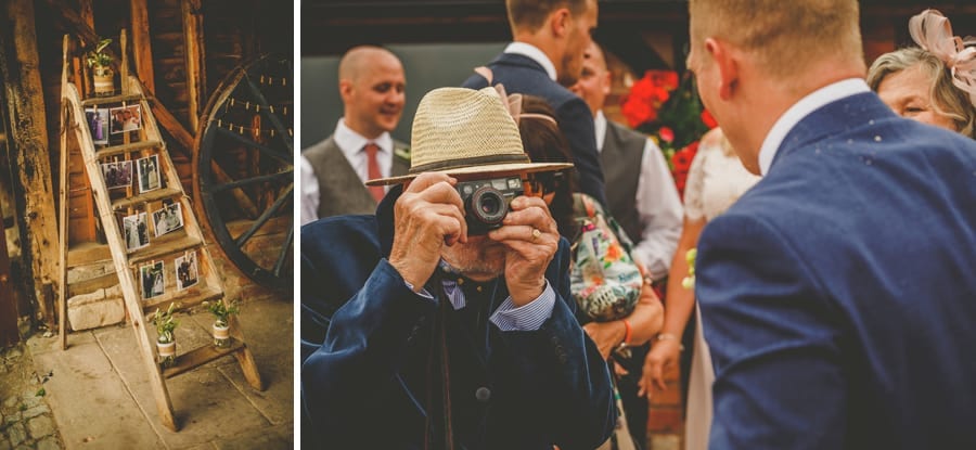The grooms grandfather takes a photograph with an old film camera of his grandson