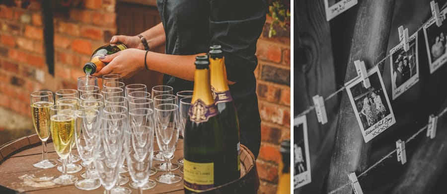 A lady pours champagne into flutes on top of a large wooden keg in the courtyard