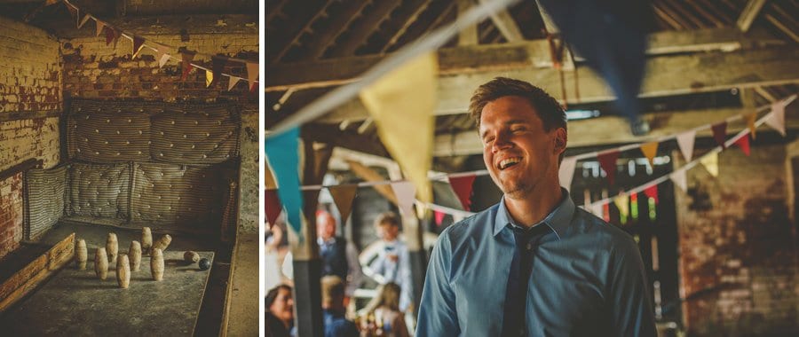 A wedding guest laughs as a ball hits skittles