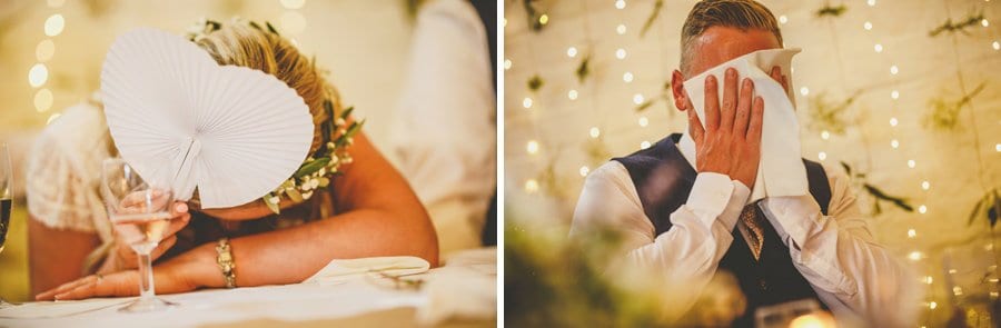 The bride and groom hide their faces during the best mans speech