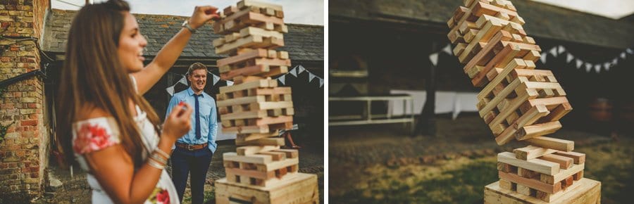 Two wedding guests play large Jenga together
