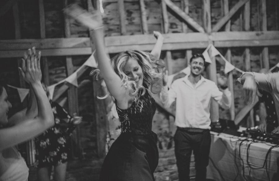 A lady throws her arms up in the air and dances at Over Barn