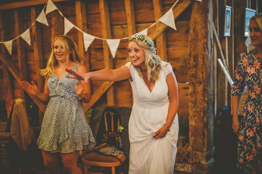 The bride holds her right arm out on the dancefloor at Over Barn
