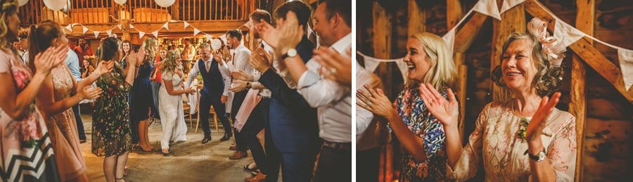 The bride and groom dancing at Over Barn while the wedding guests gather round