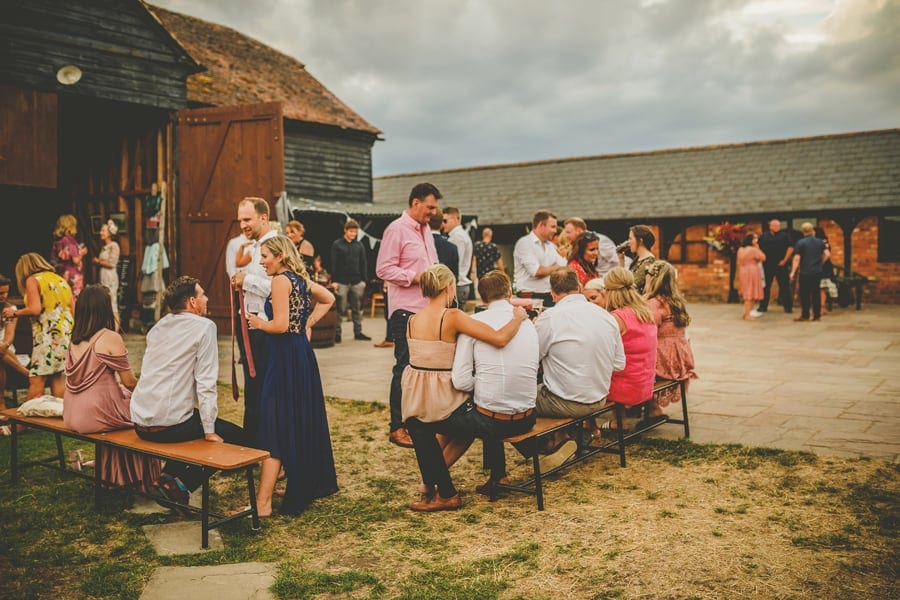 Wedding guests congregate in the courtyard at Over Barn