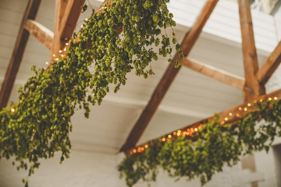 Flowers hang from the large wooden beams at Silk Mill Studios