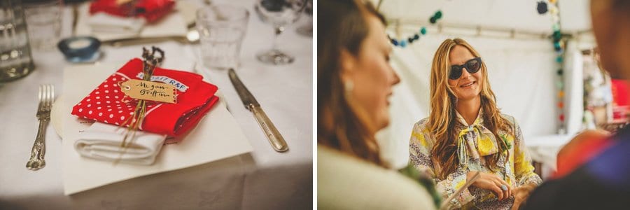 A wedding table is set and a wedding guest talks with friends