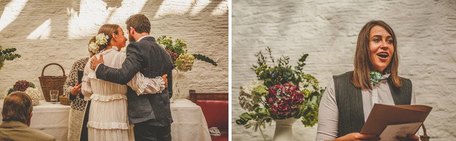 The bride and groom put their arms around each other during the wedding ceremony