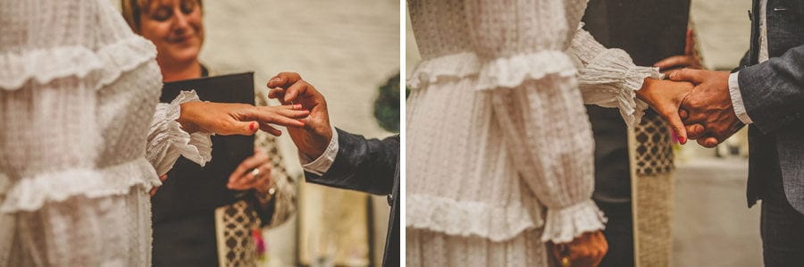 The bride and groom exchange rings during the wedding ceremony at Silk Mill Studios