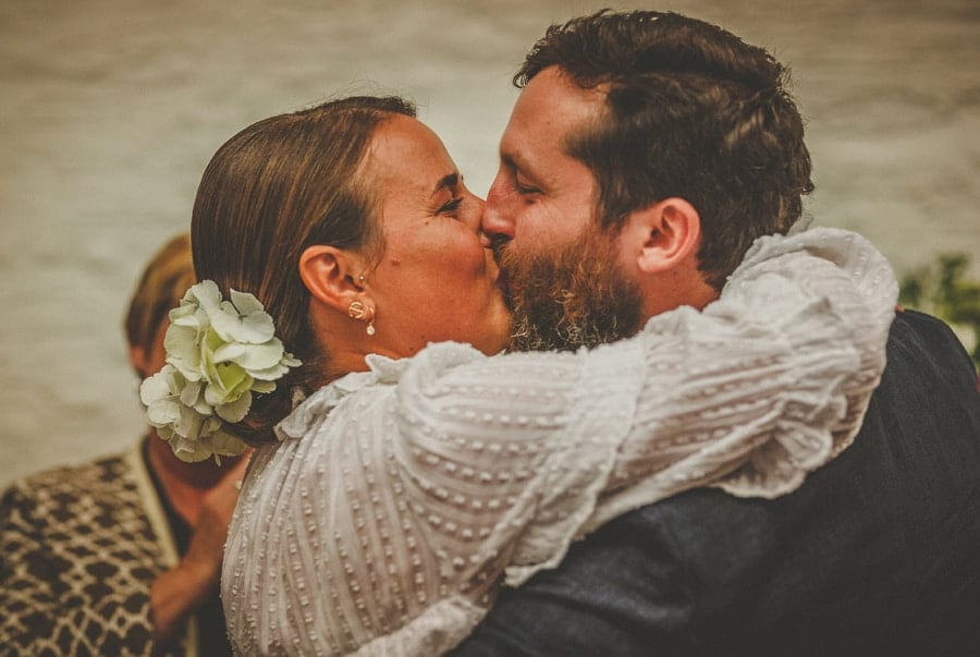 The bride and groom kiss each other