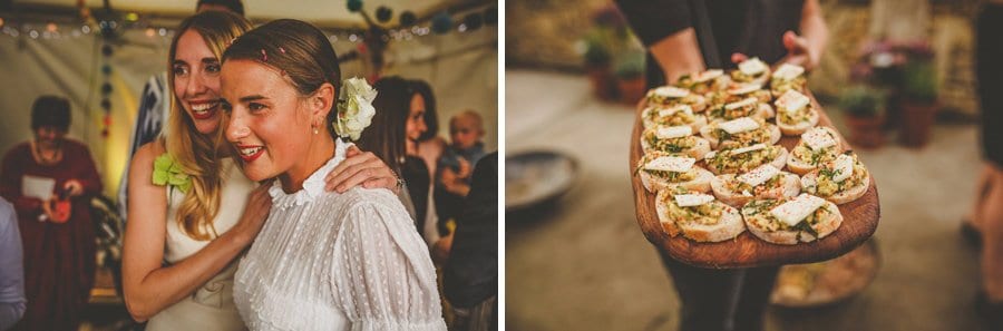 A bridesmaid congratulates the bride and a lady holds out a wooden board of canapes