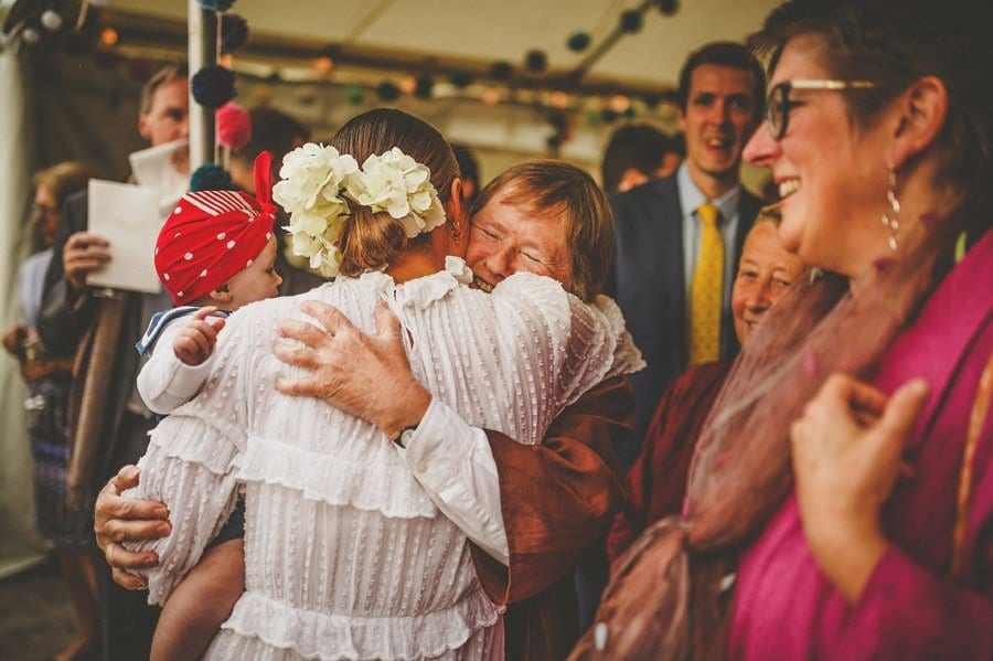A family member puts her arms around the bride