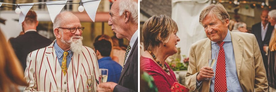 The bride and grooms family talk with friends in the courtyard
