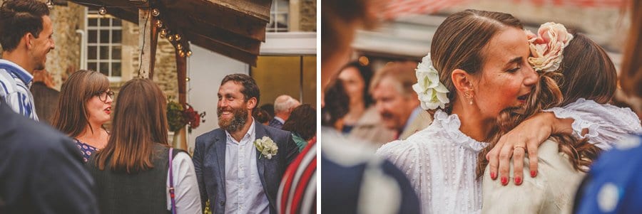 The bride and groom chat with friends and family in the courtyard at Silk Mill Studios in Frome