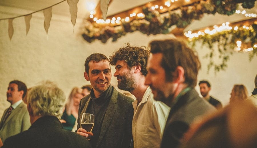 Wedding guests chat to each other on the dance floor