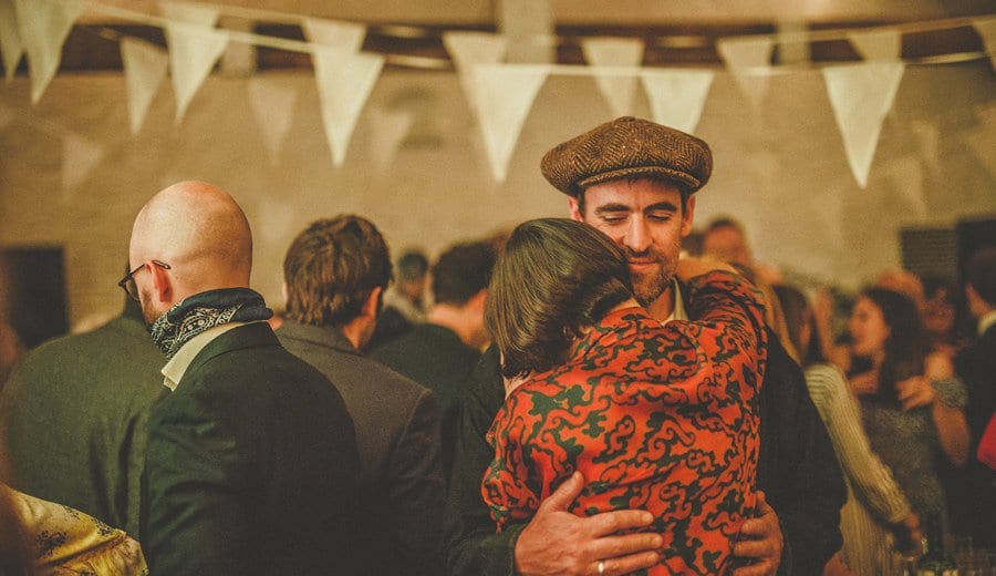 A wedding guest dancing with his wife on the dancefloor