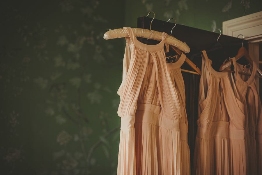 The brides dresses hang from the door in the Master bedroom