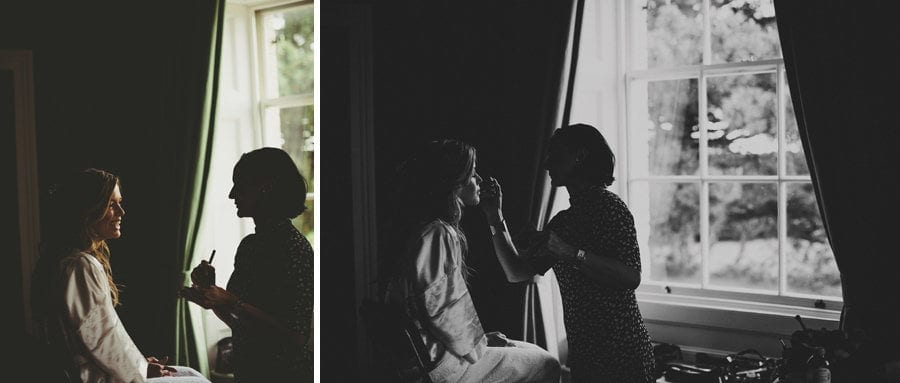The bride sits next to a window in the Master bedroom