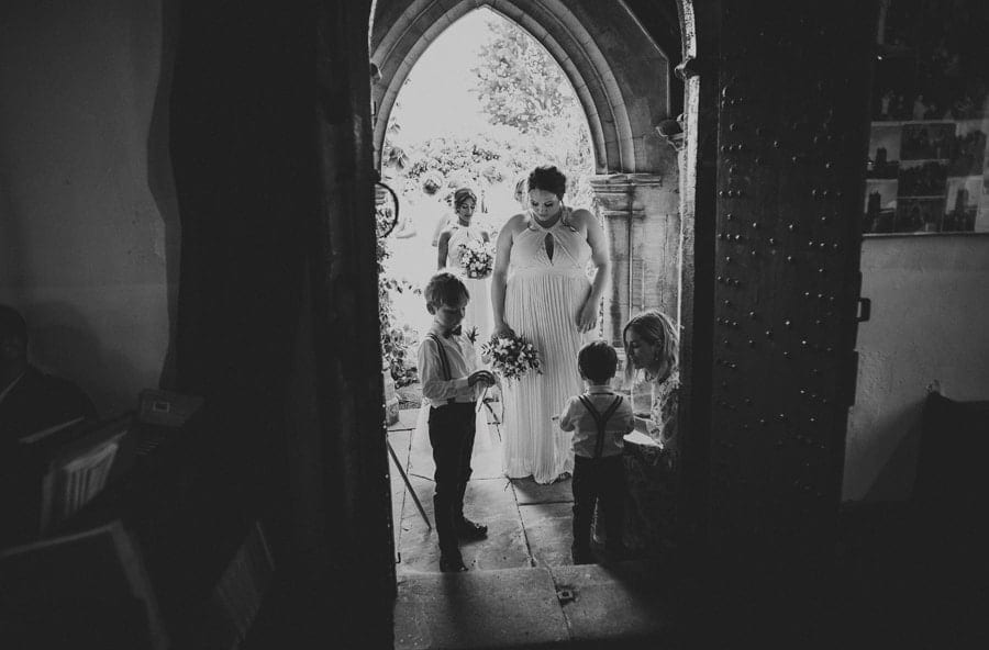 Bridesmaids and page boys arrive at the entrance of the Church