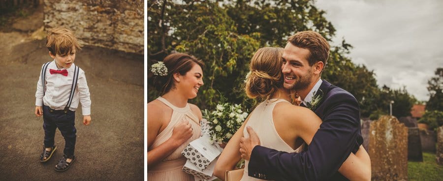 A little boy watches as the groom puts his arms around a bridesmaid
