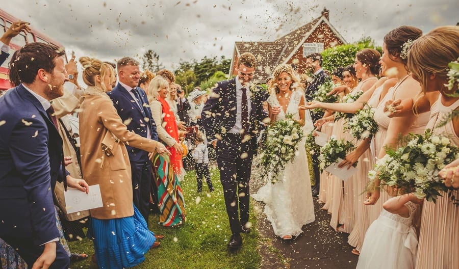 Confetti is thrown over the bride and groom