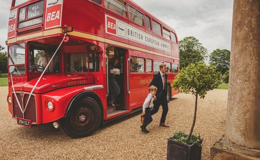 Wedding guests arrive at Stubton Hall and walk off the wedding bus