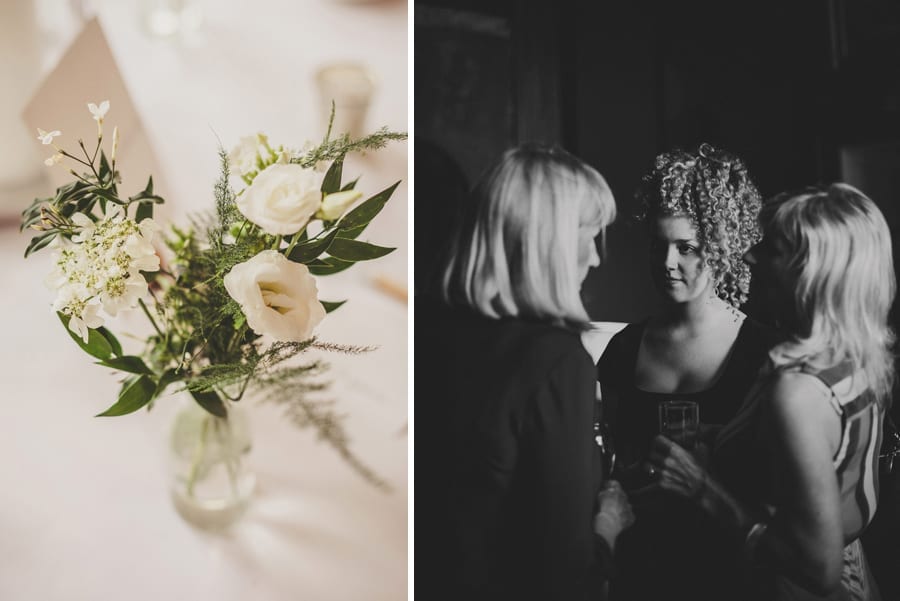 Wedding flowers on the table and guests talking to each other in the Library