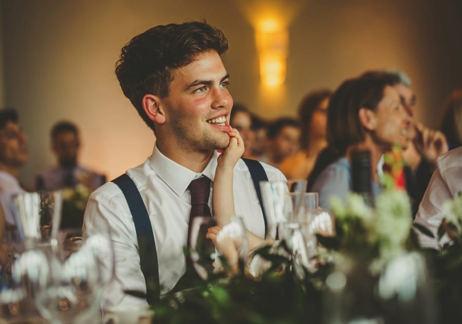 The brides brother smiles during his father's speech