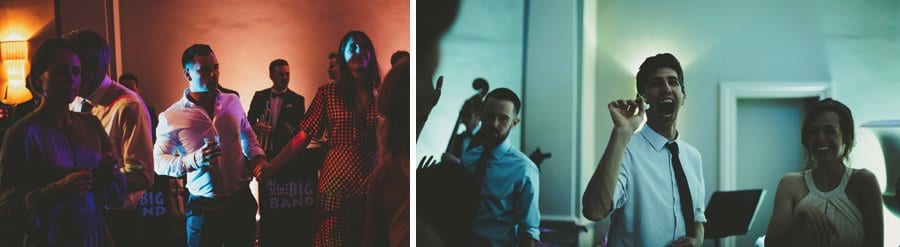 A wedding guest throws a flower at a friend on the dancefloor