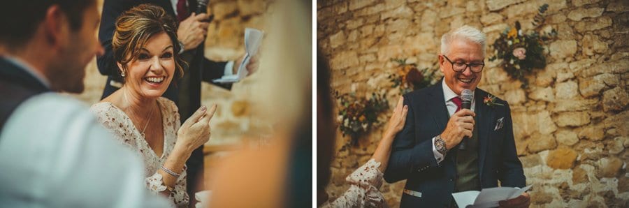 The brides mother laughs at her husband's speech in the Tithe Barn, Symondsbury
