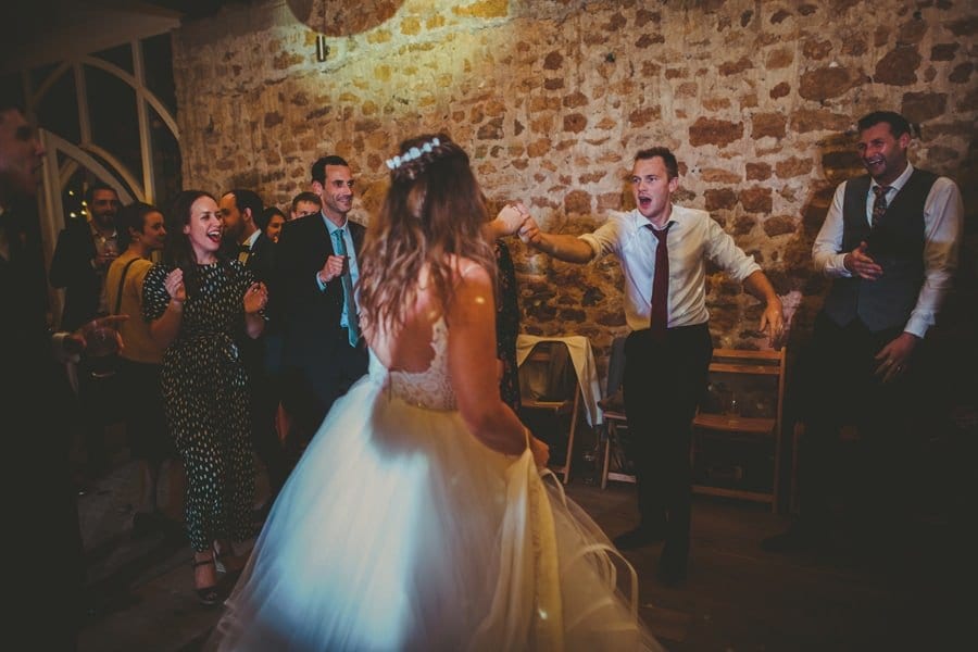 The bride dances with a wedding guest on the dancefloor