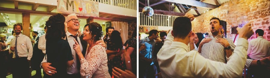 The bride's family hold each other and smile on the dancefloor