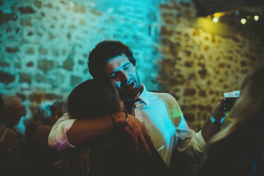 A wedding guest holds his wife on the dancefloor