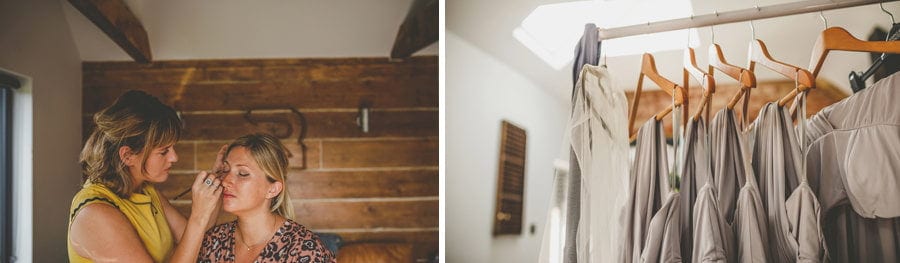 The makeup artist applies make up to the face of one of the bridesmaids