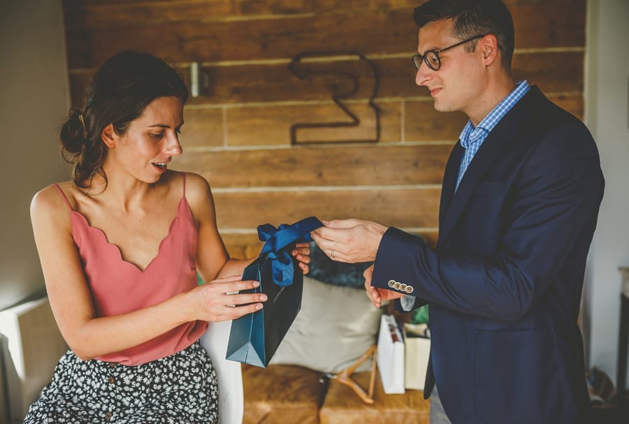 A man gives the bride a wedding gift in the cottage