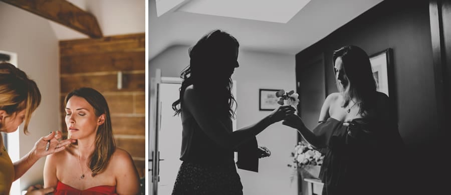 A bridesmaid gives the bride a flower in the hallway of the cottage