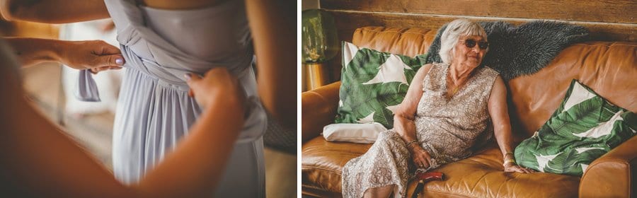 A bridesmaid ties the straps at the back of one of the bridesmaids dresses