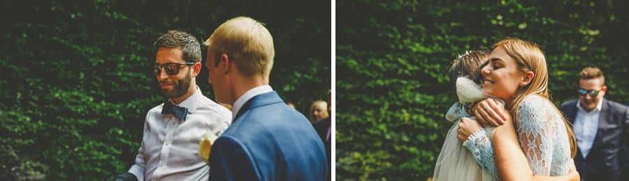 A wedding guest puts her arms around the bride