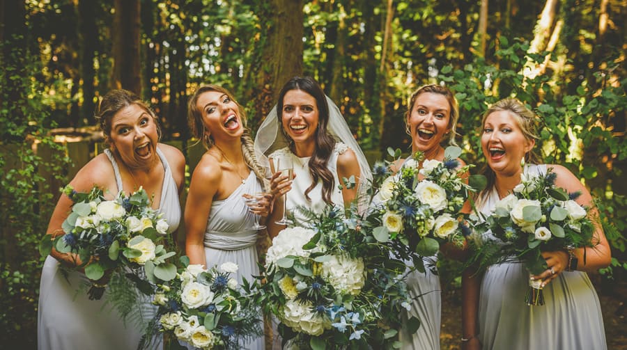The bride and bridesmaids pose for a photograph with their bouquets