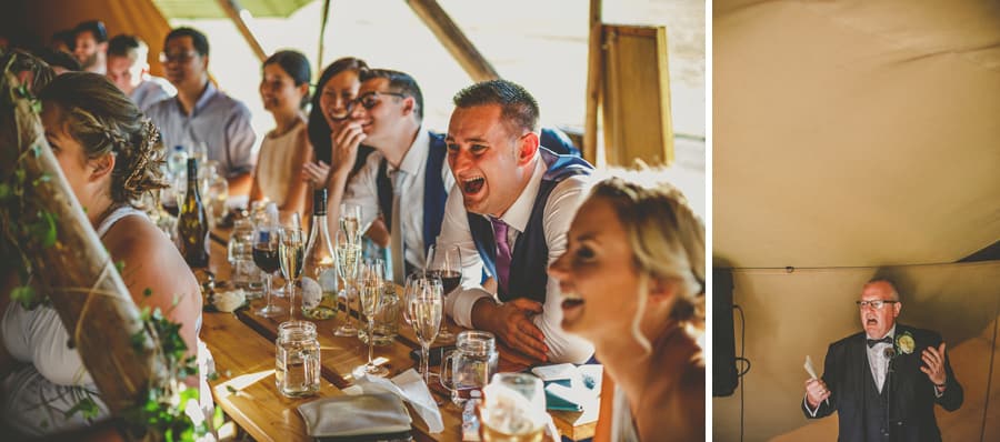 Wedding guests laugh at the brides fathers wedding speech in the tipi