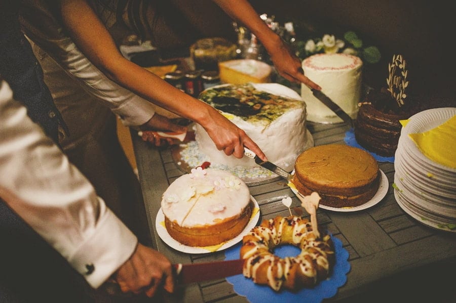The bride and groom cut the wedding cakes in the tipi at yurt retreat
