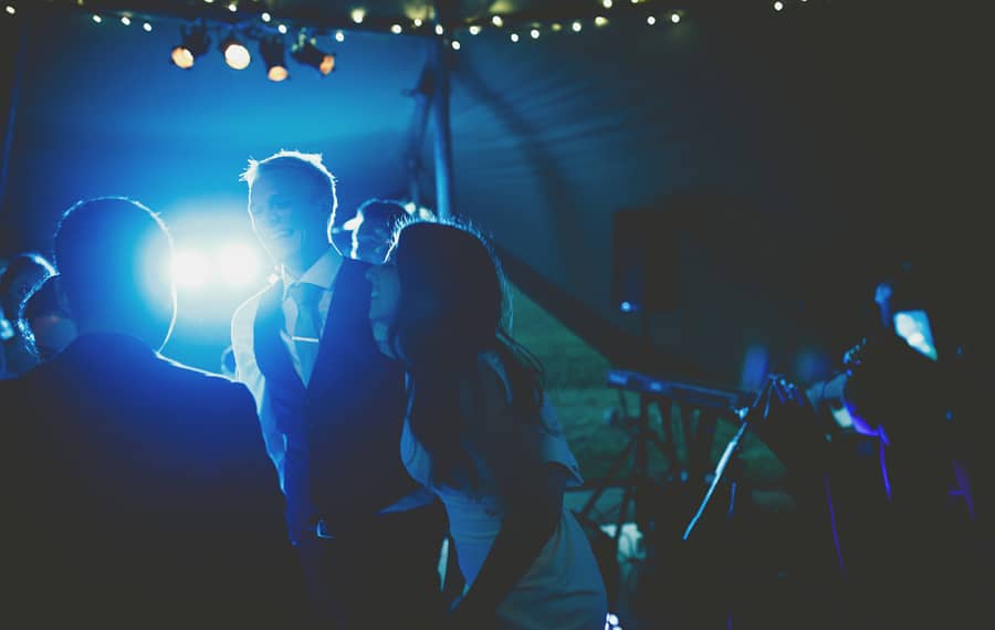 The bride dances with the groom on the dancefloor