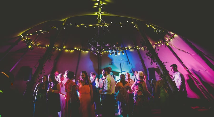 Wedding guests on the dancefloor in the tipi at yurt retreat